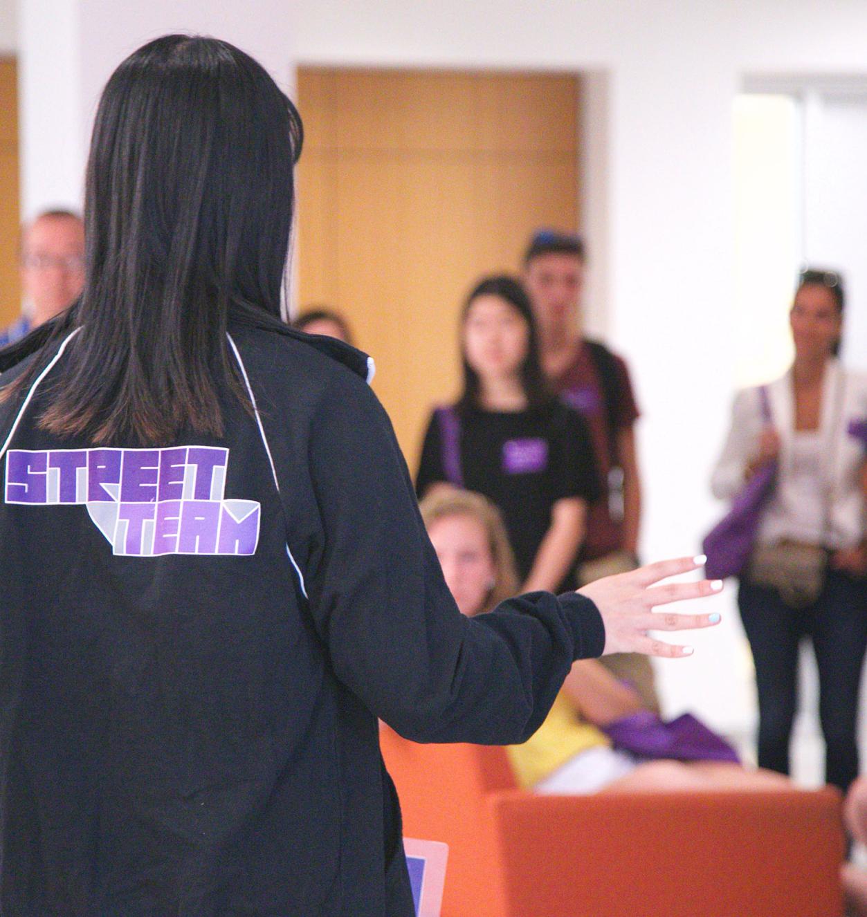 A student speaks in front of a crowd