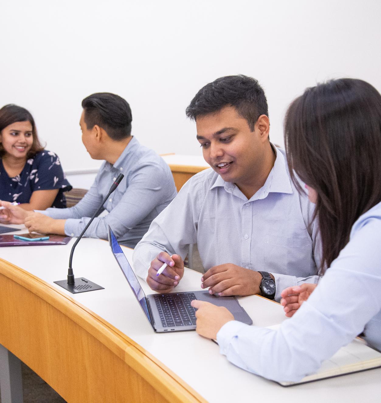 Four people collaborating in a classroom