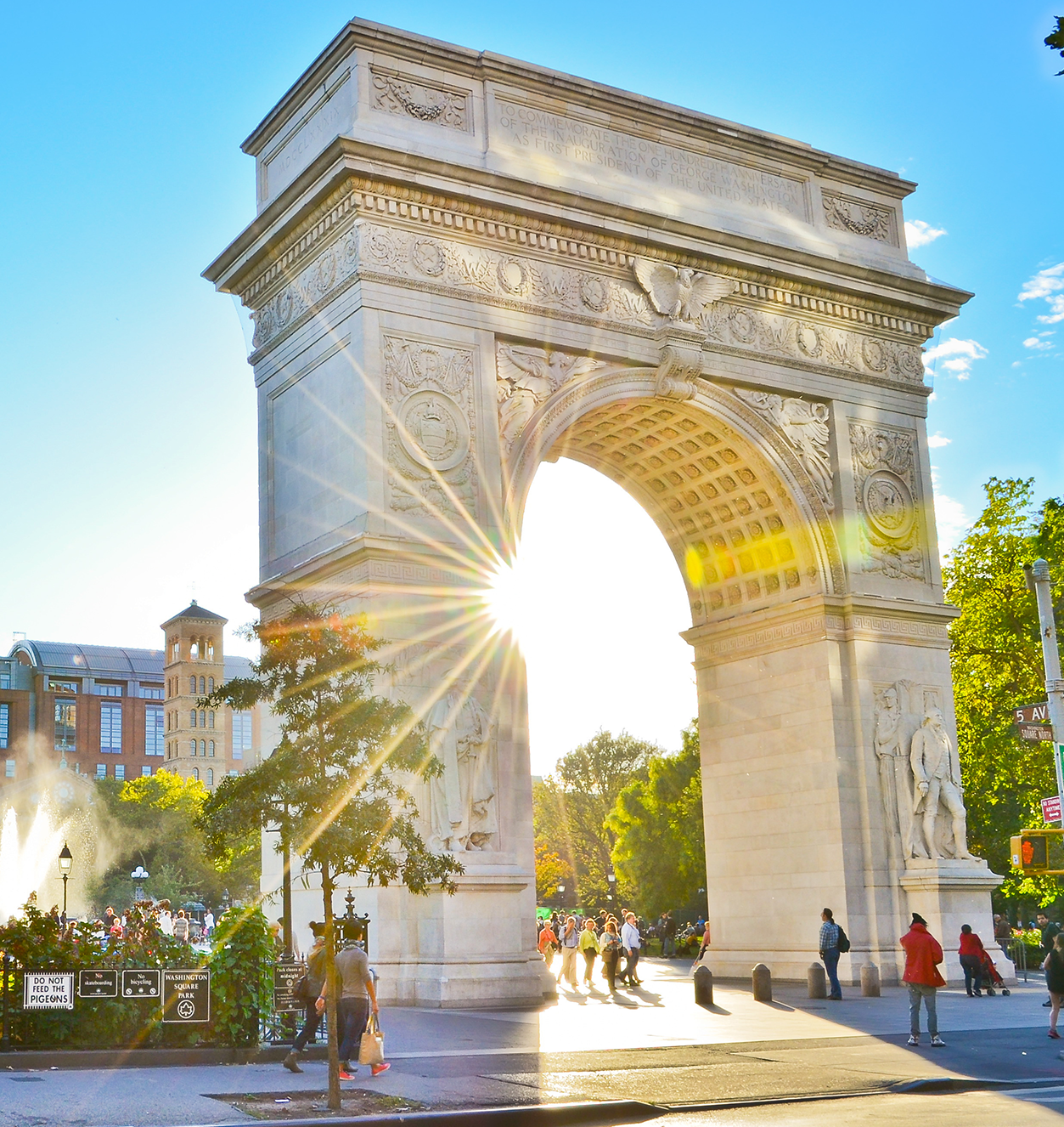Washington Square Arch backlit by sun 