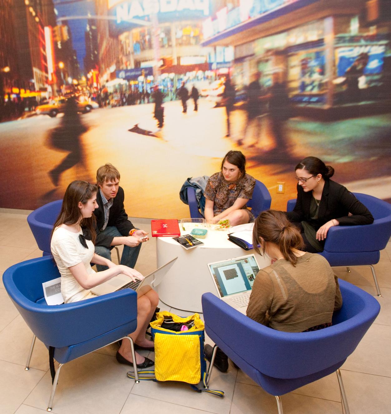 Students seated around a low table in the lounge Students seated around a low table in the lounge