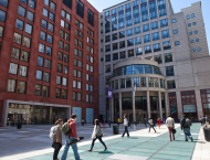 A photo of people walking in front of KMC and Tisch Hall.