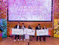 winners of the entrepreneurs challenge holding prize checks with confetti falling down