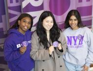 Students pose to support NYU One Day