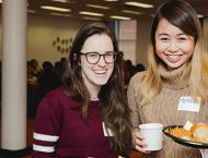 Two student smiling and posing with food