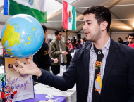 Student holding up globe at Passport Day