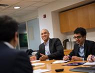 Dean Emeritus and Professor Peter Henry meets with students. 