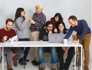 a group of people at a table collaborating 