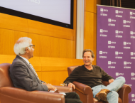 Dan Schulman smiles as he speaks to Dean Sundaram