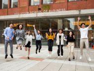 Students are pictured jumping after the NYU Stern and NYU Shanghai orientation. 