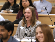 Woman in classroom with other students smiling
