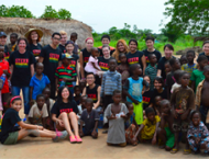 Stern students posing with children of Ghana