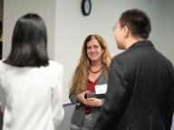 Vice Dean Mor Armony smiling and looking at two people. 