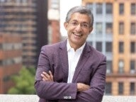 Dean Bharat Anand standing outside smiling 