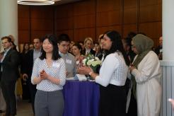 Reception attendees listening to speakers at the event