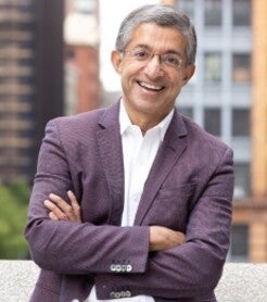 Dean Bharat Anand standing outside smiling 
