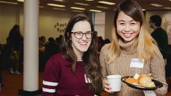 Two student smiling and posing with food