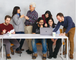 a group of people at a table collaborating 