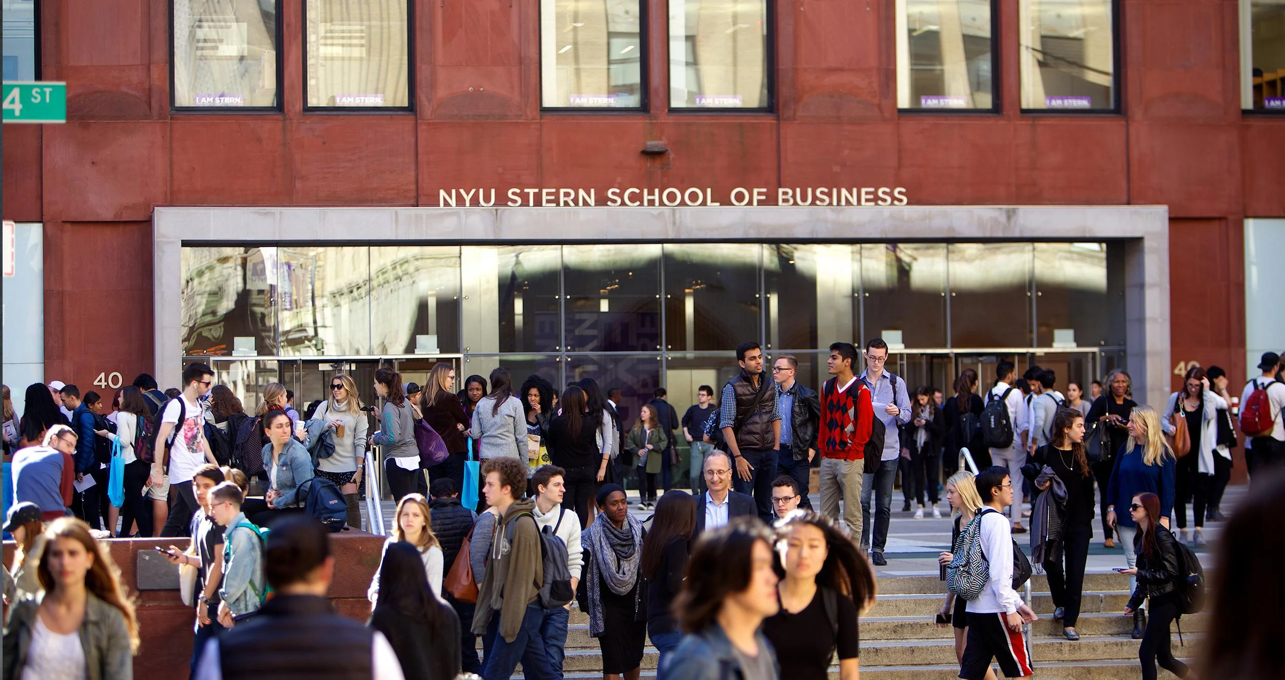 Students huddle in front of Stern Business School 