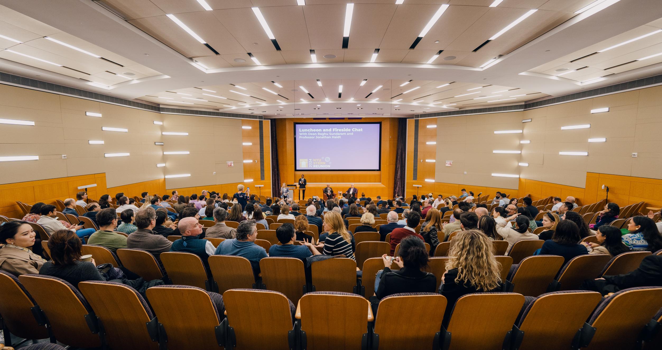 Stern alumni gather at a lecture as part of Reunion 2024