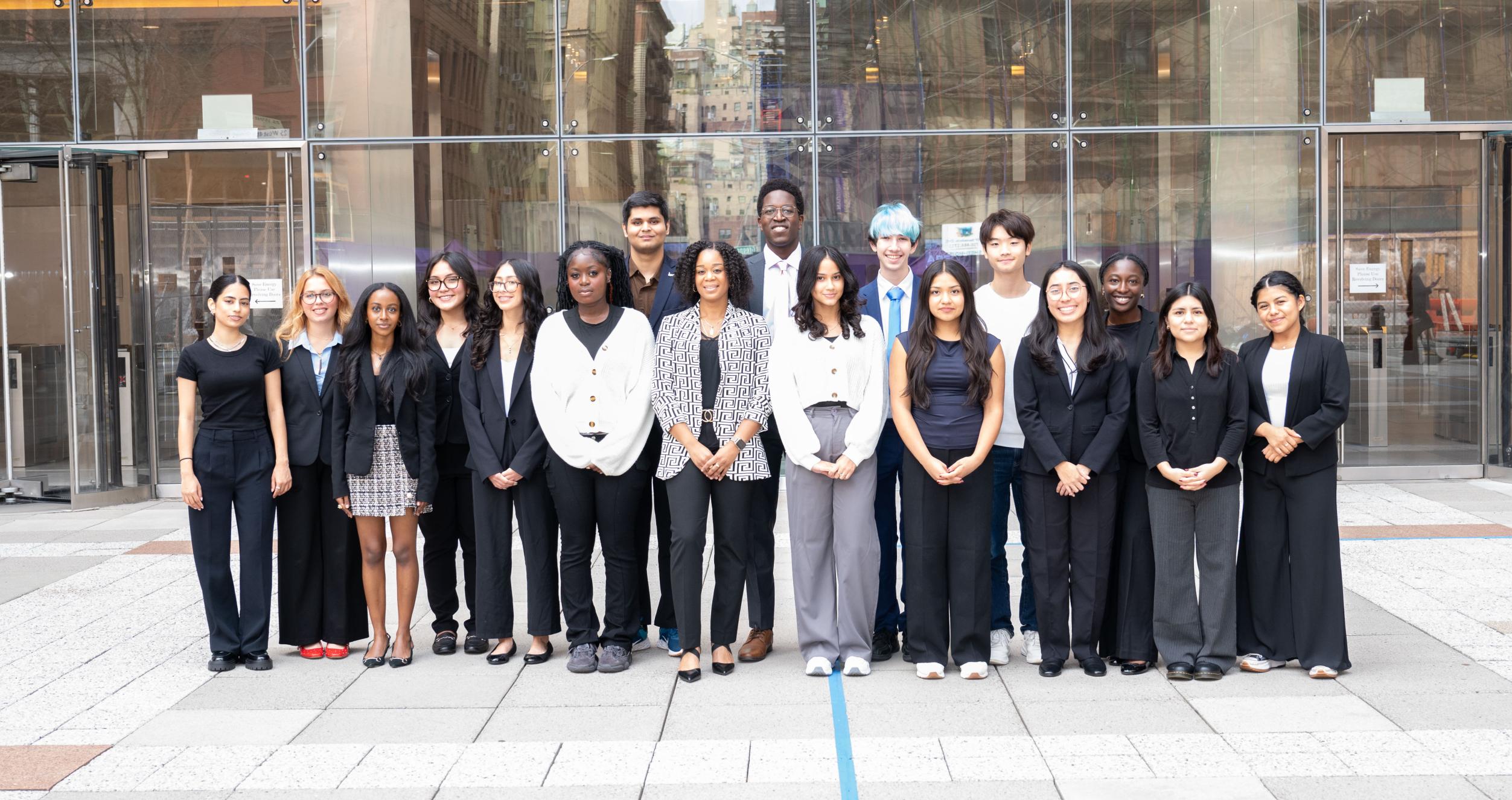 Stern business academy members grouped together looking at the camera