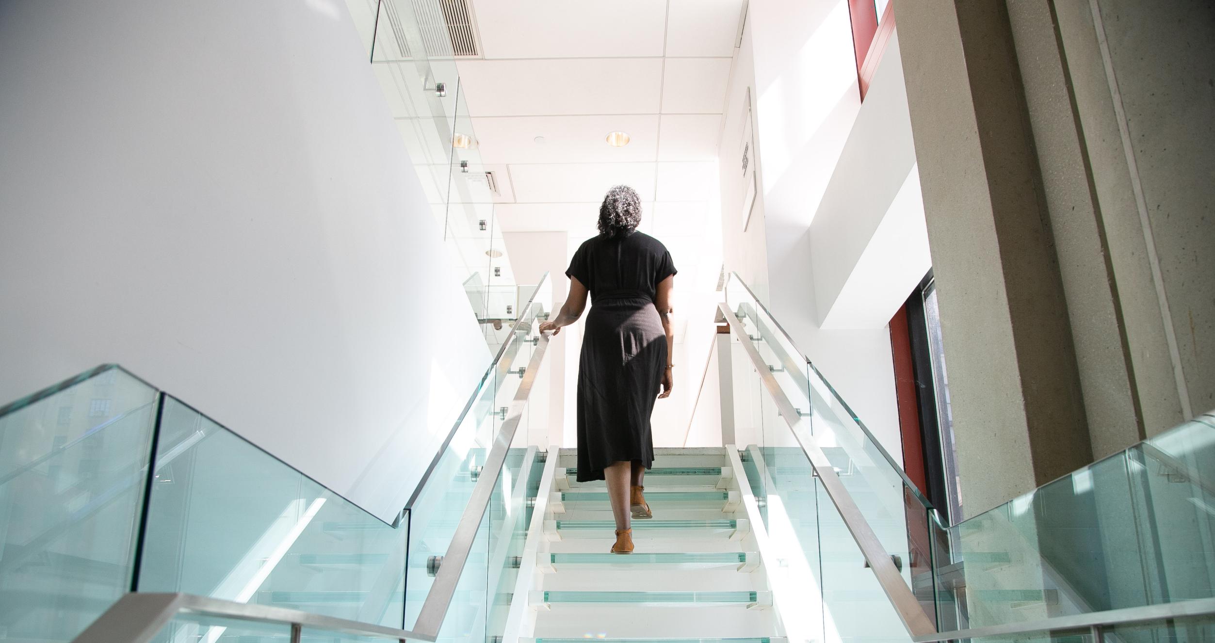 Woman walking up staircase