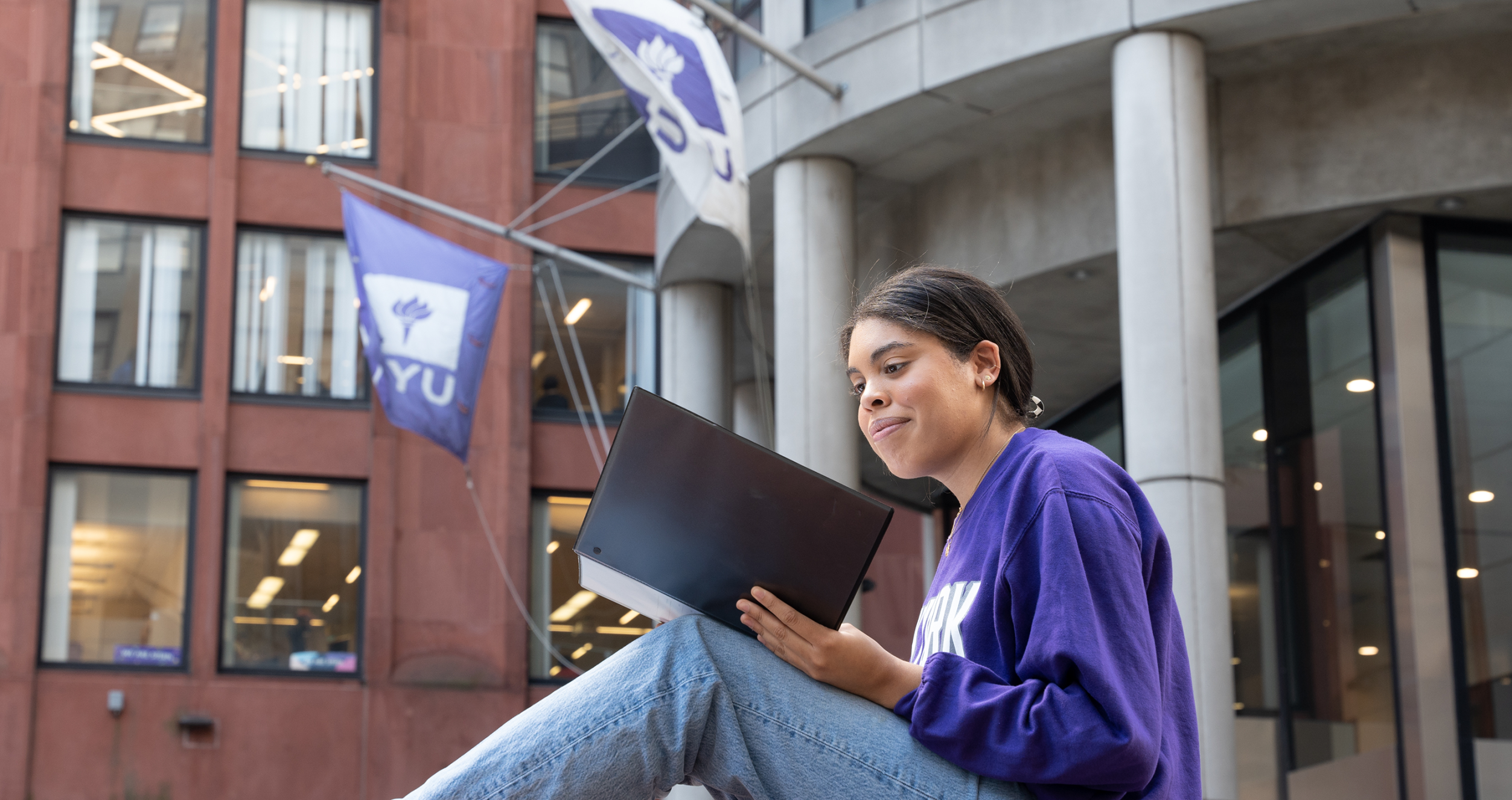 A student poses on Gould Plaza