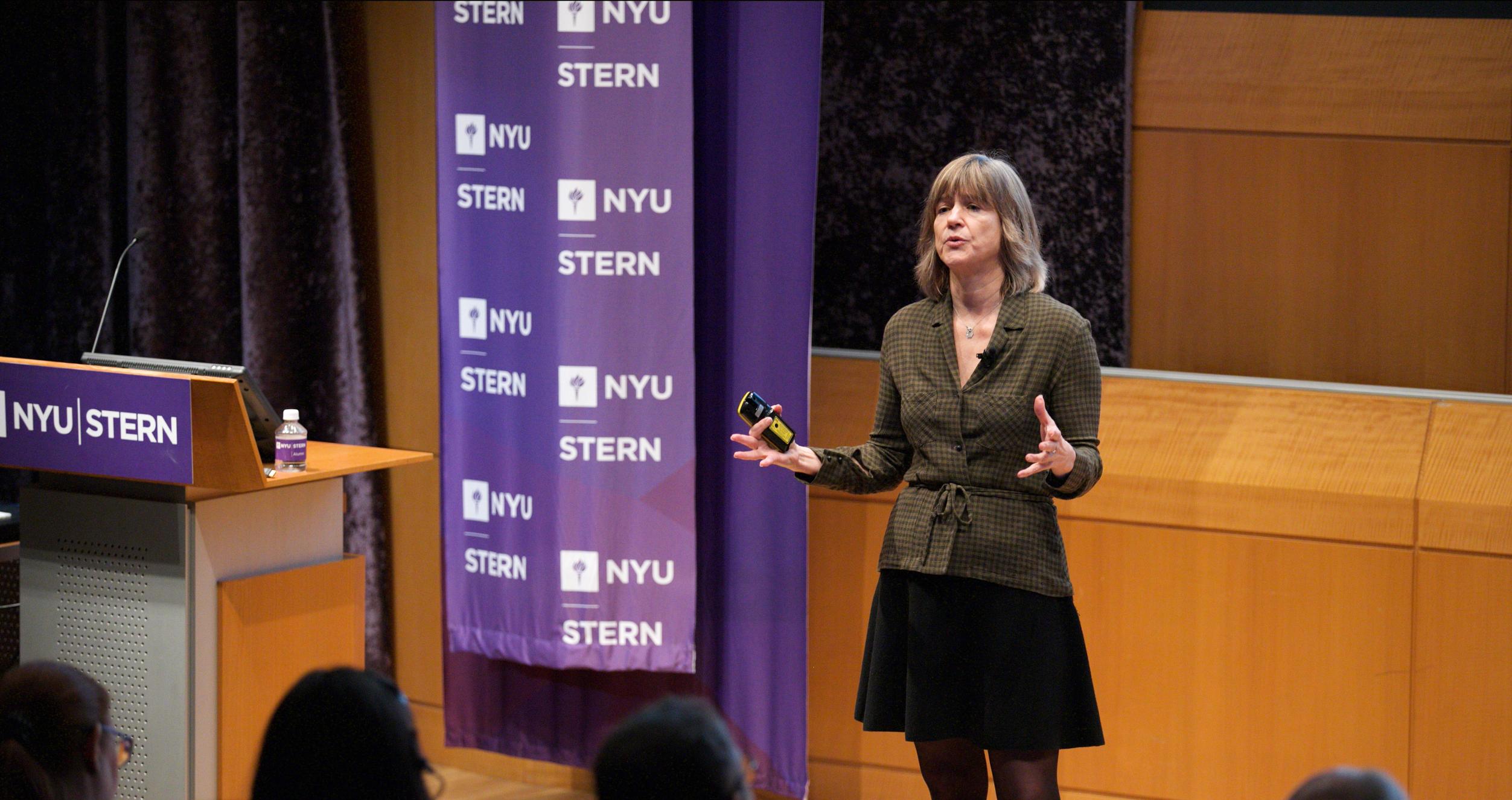 Tensie Whelan speaks in front of auditorium audience