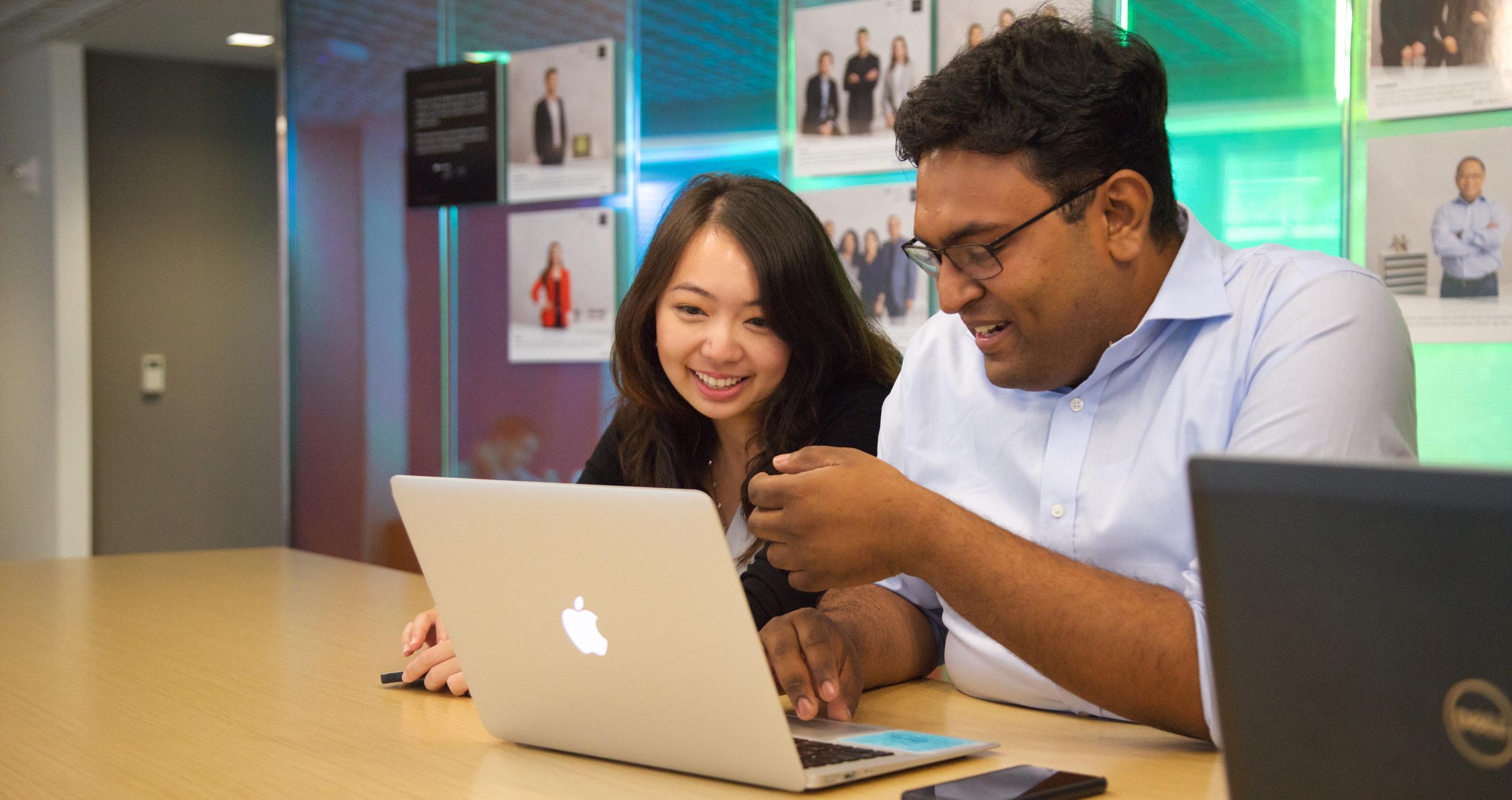 Alumni Resources Students looking at laptop