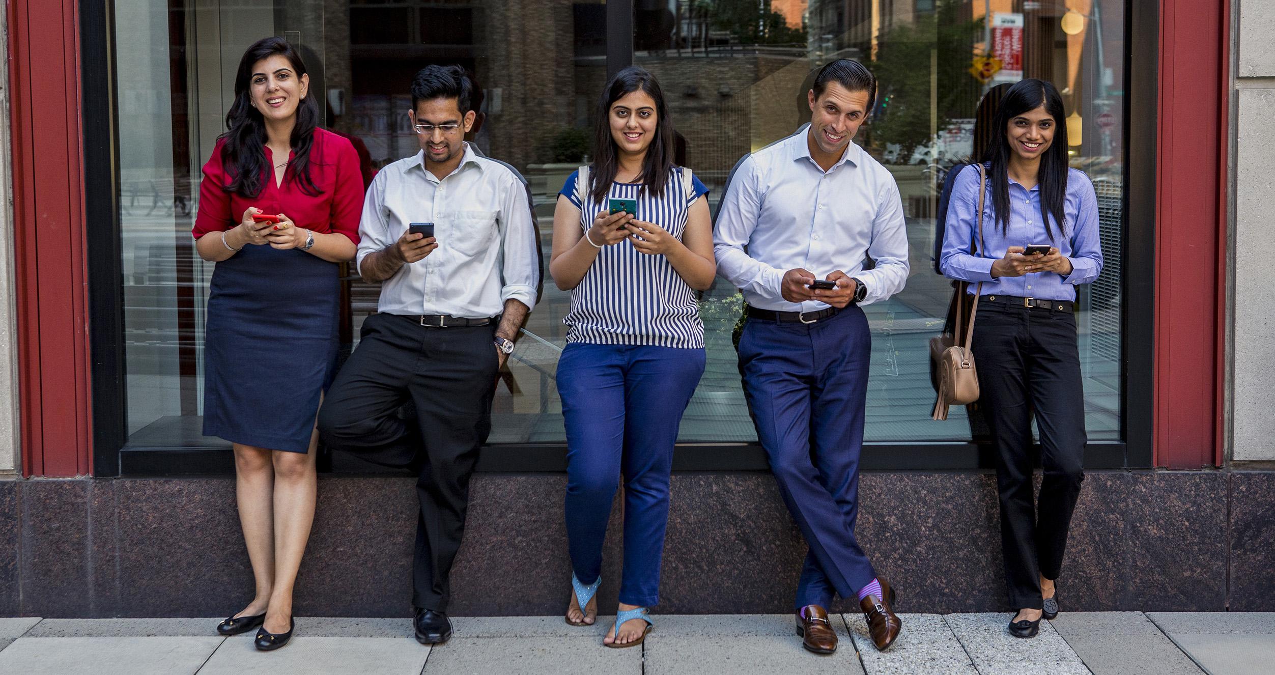 Students on their phones in Gould Plaza