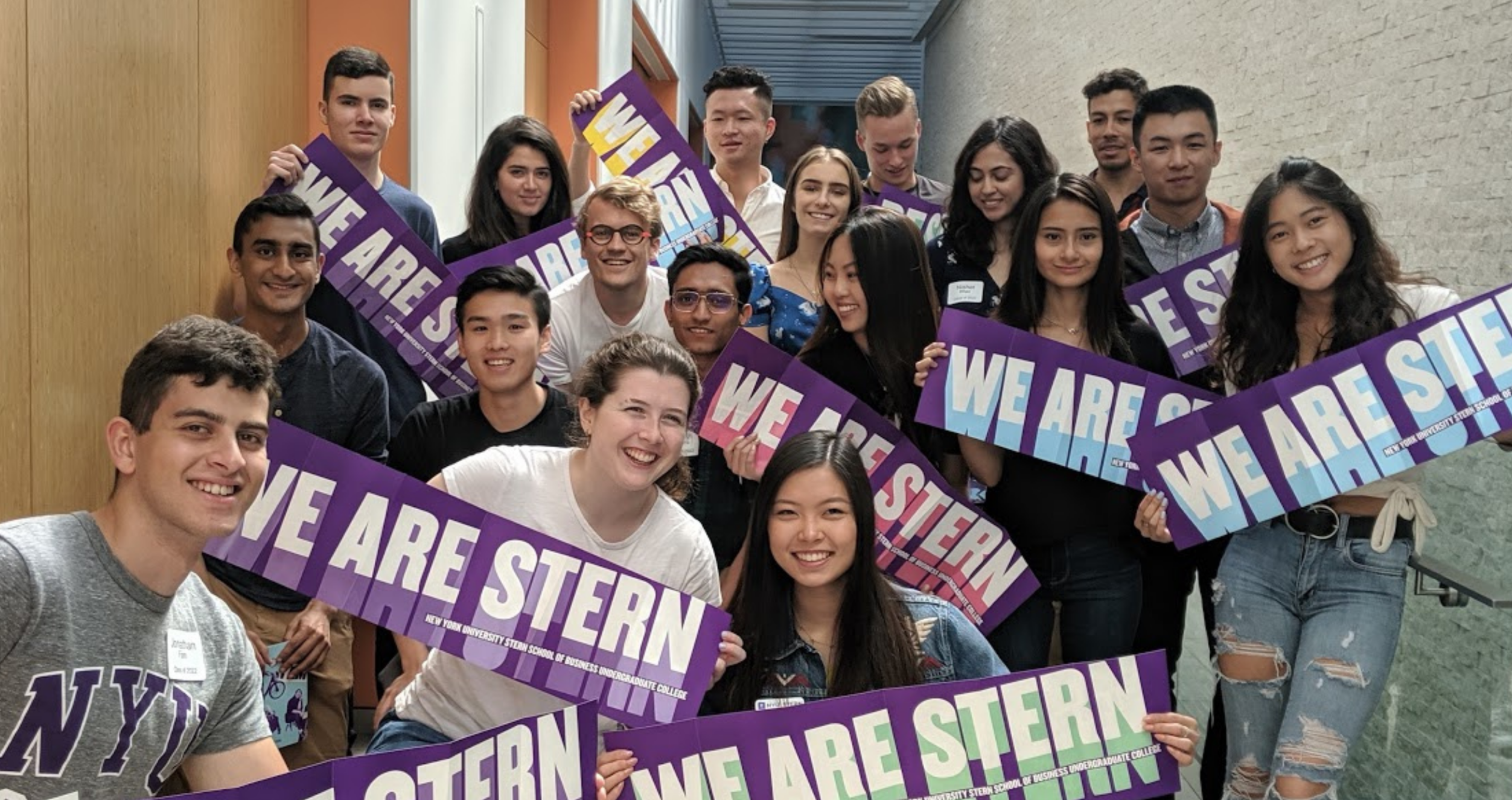 Transfer students at 2019 Orientation hold up a banner