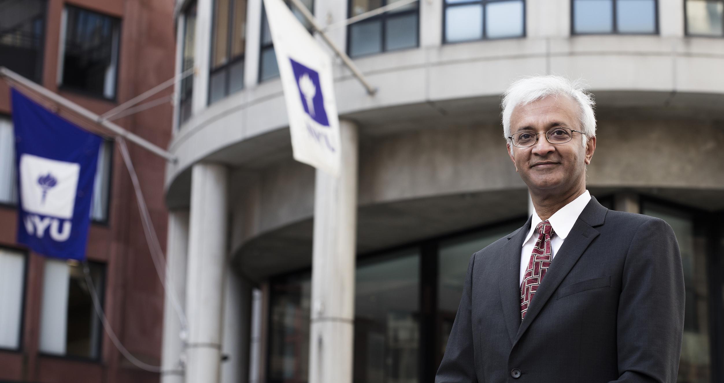 Raghu Sundaram standing in front of Kaufman Management Center