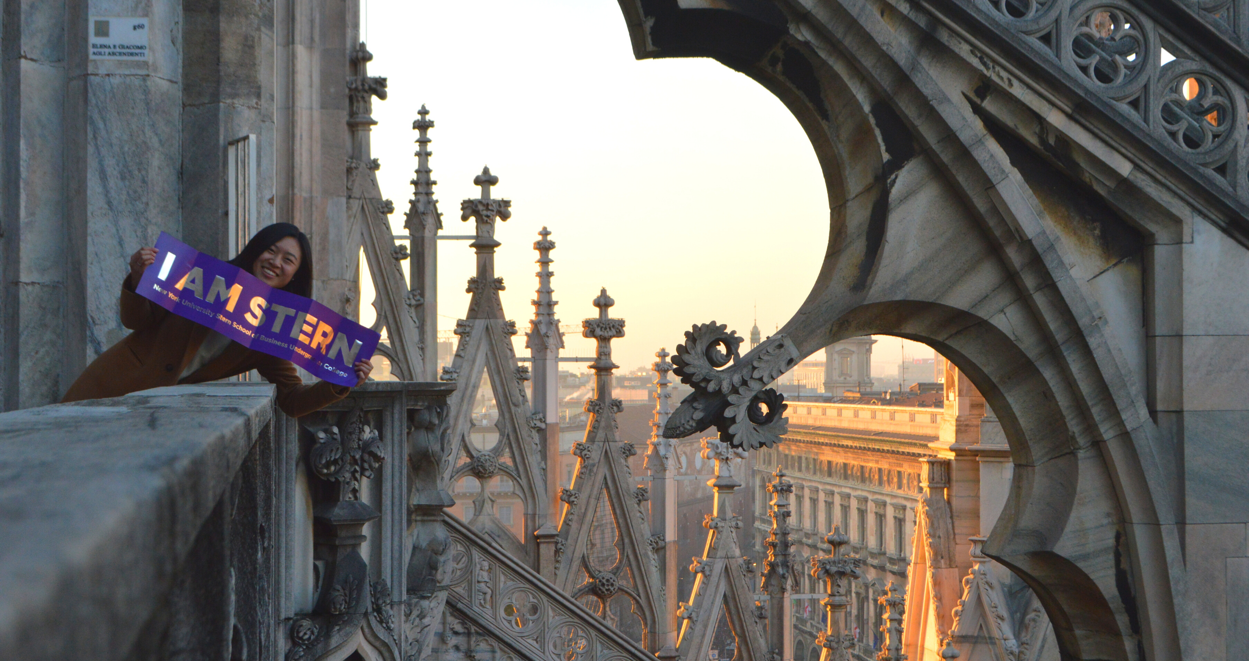 A student on IBEX holds a banner