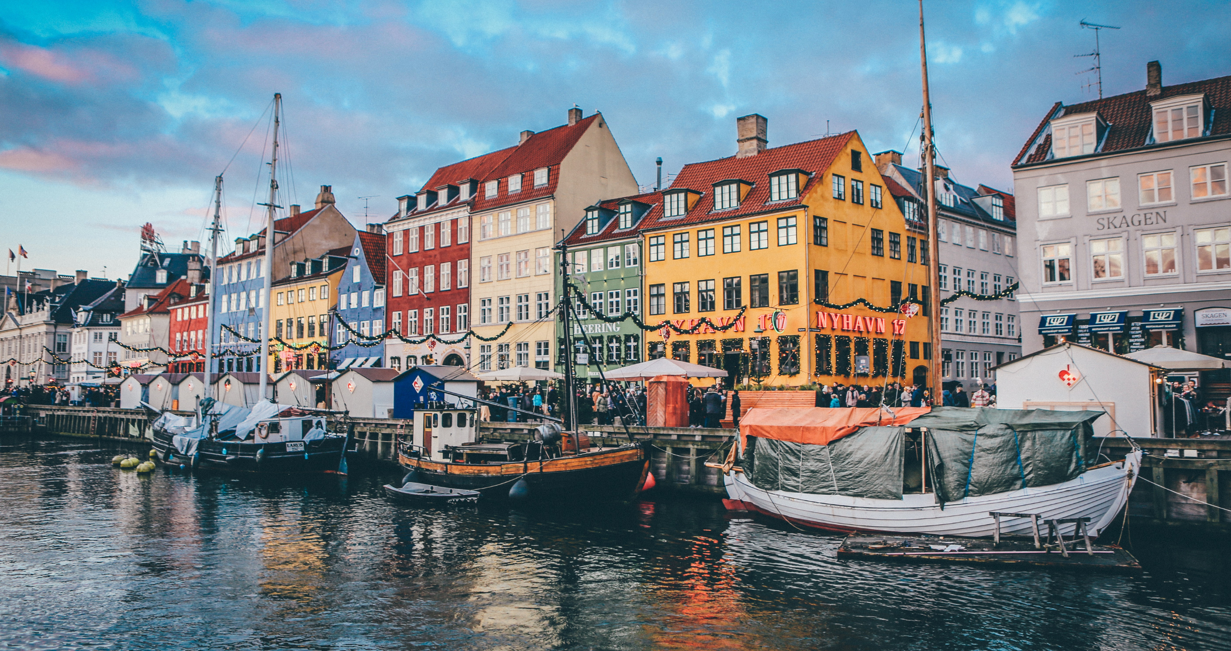 Buildings and boats line a channel in Copenhagen