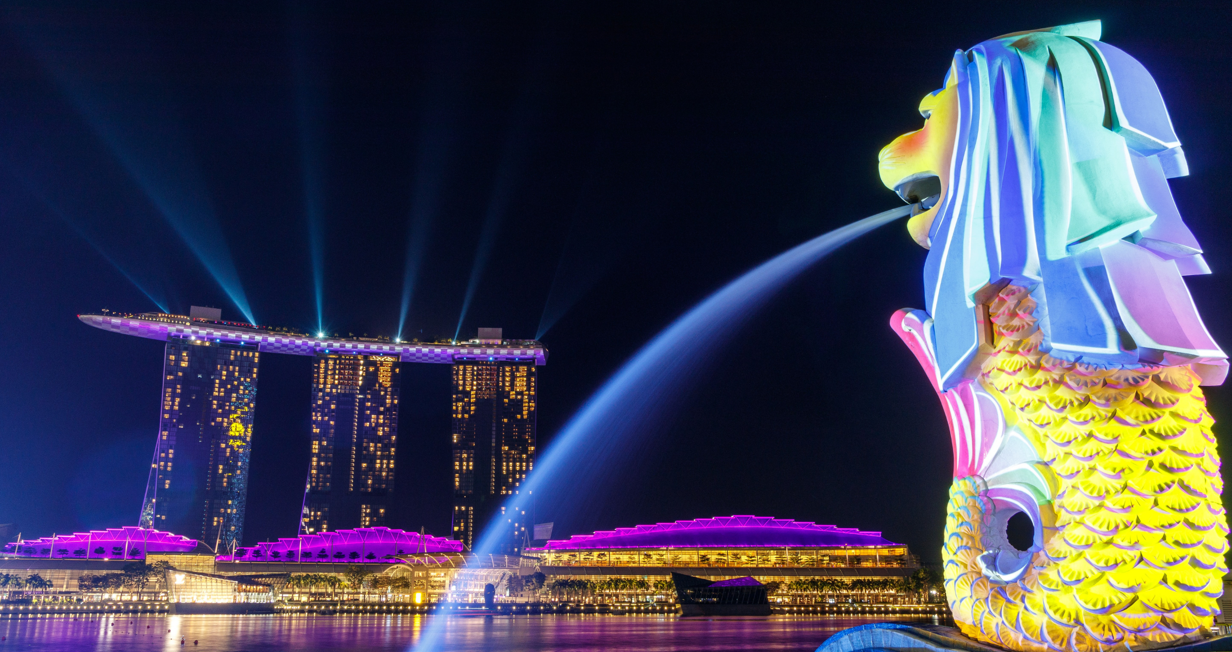 Singapore's landmarks are lit up at night.