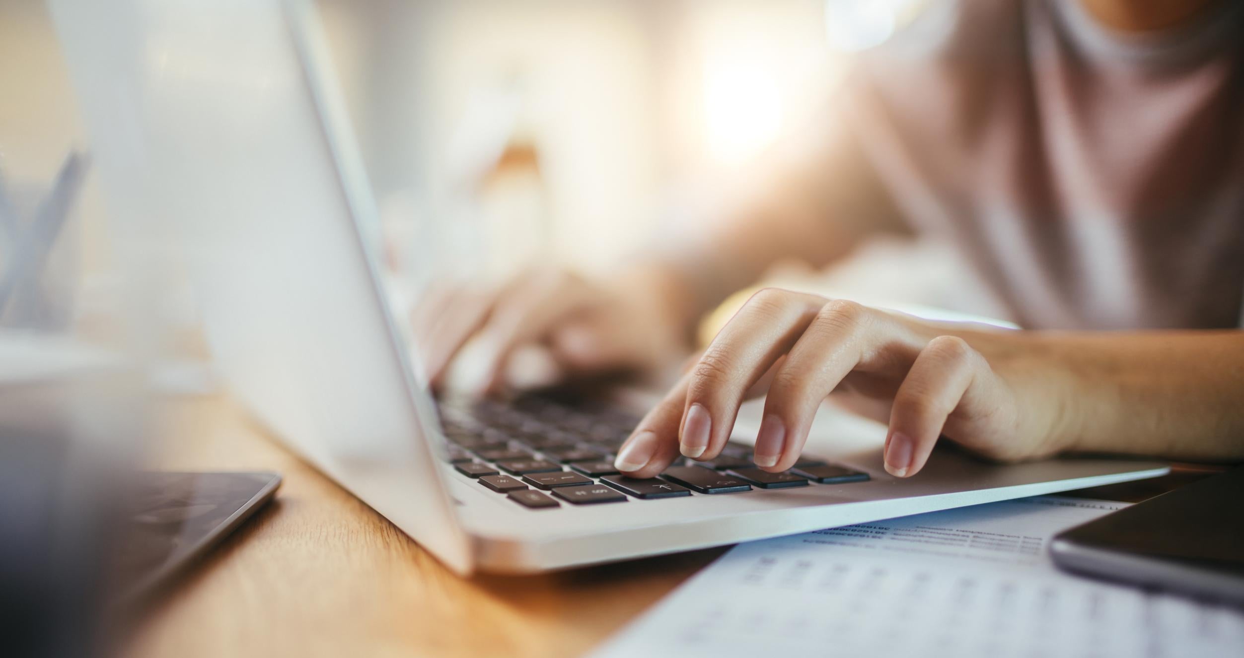 Girl typing on a laptop 