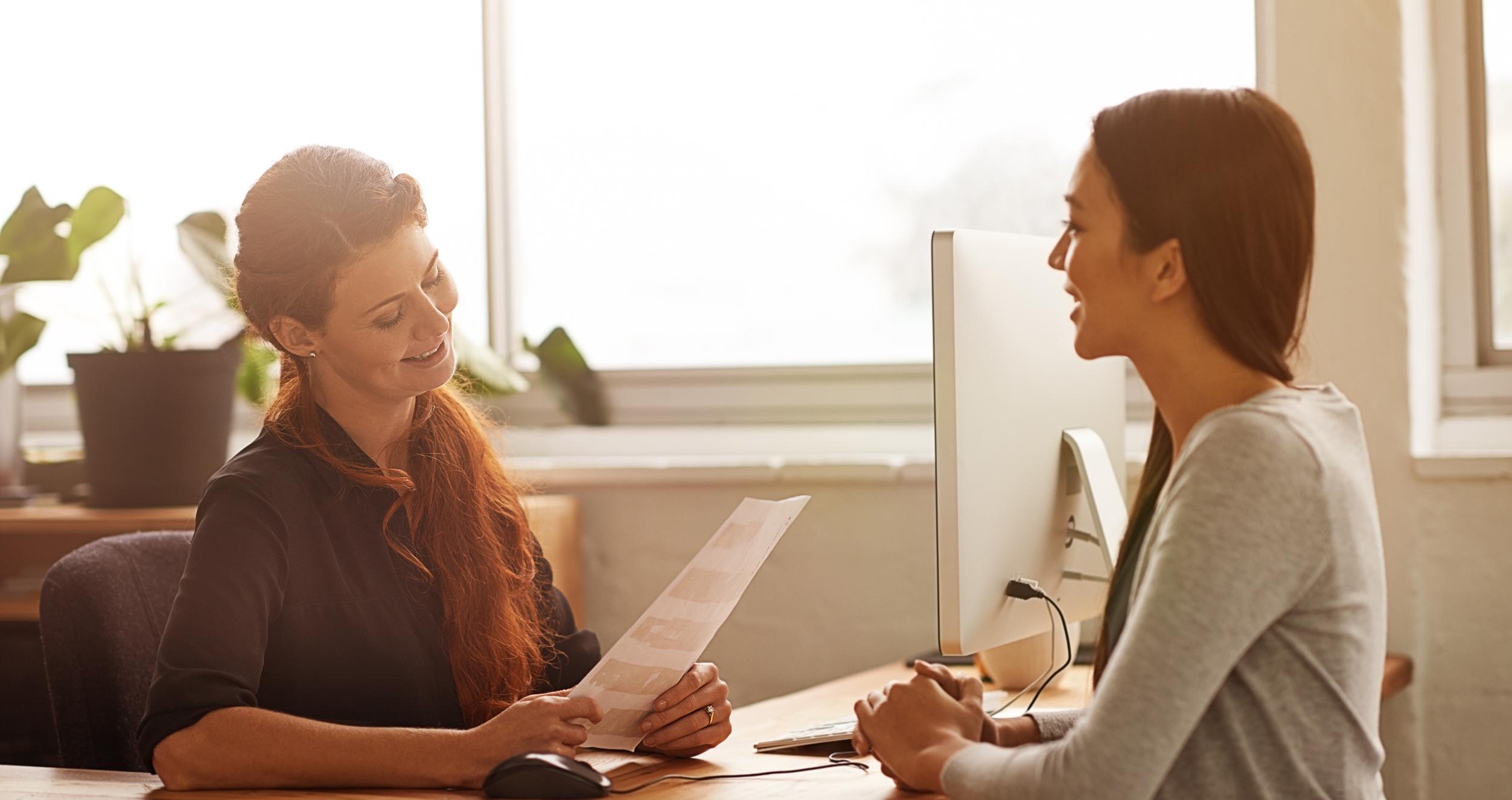 A woman conducts an interview for a female candidate 