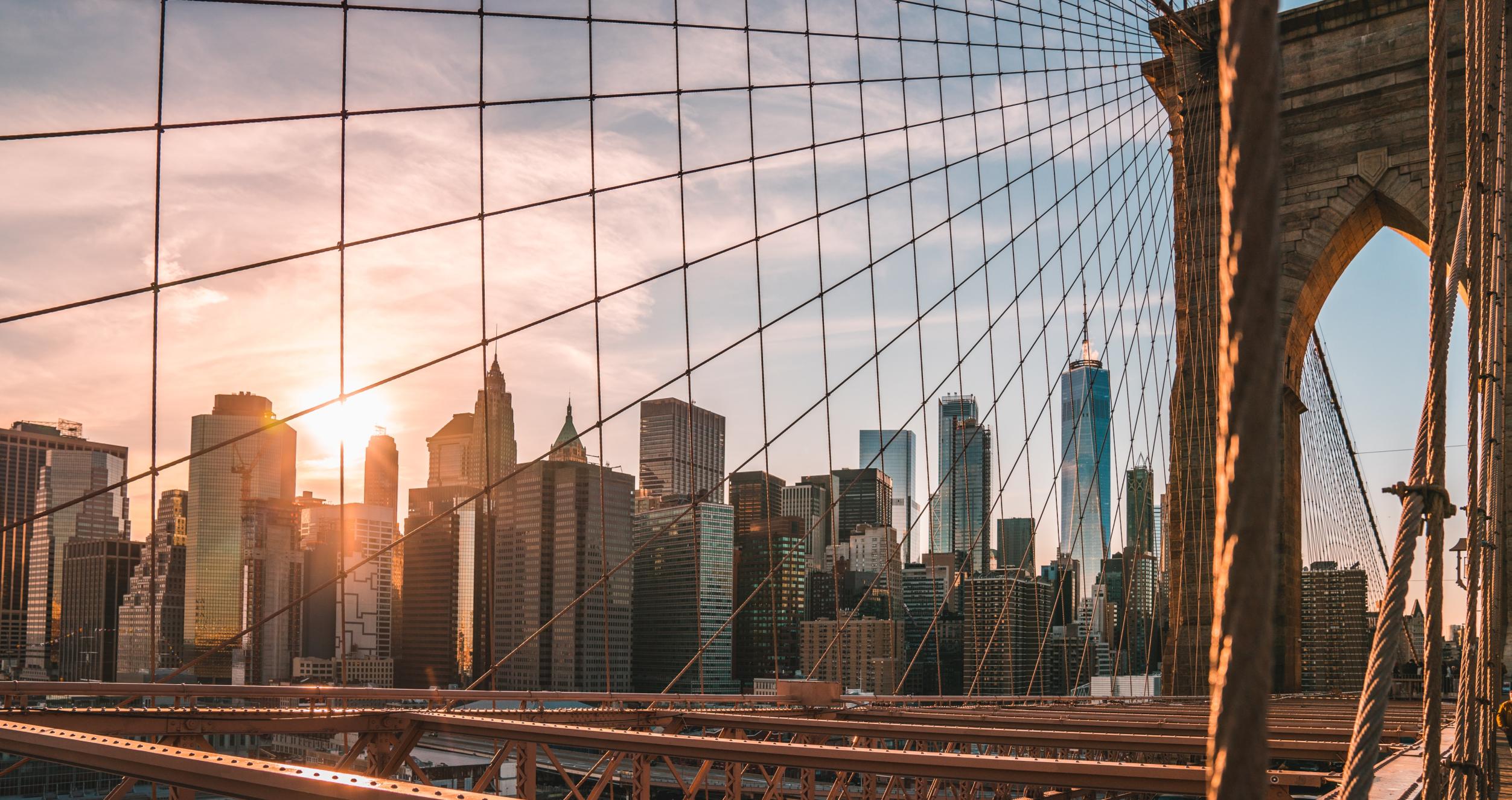 Financial district skyline through the Brooklyn Bridge