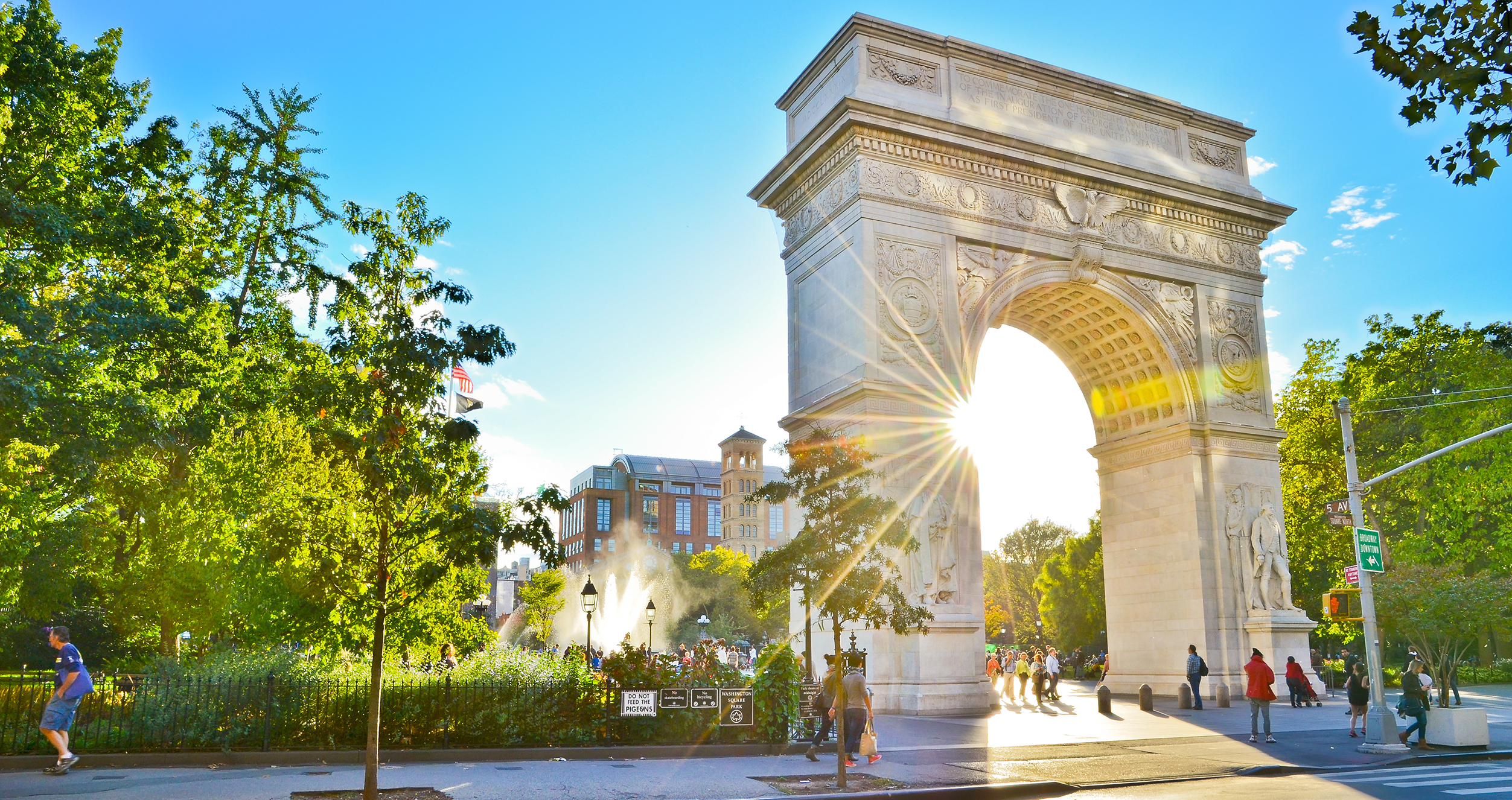 Washington Square Arch backlit by sun 