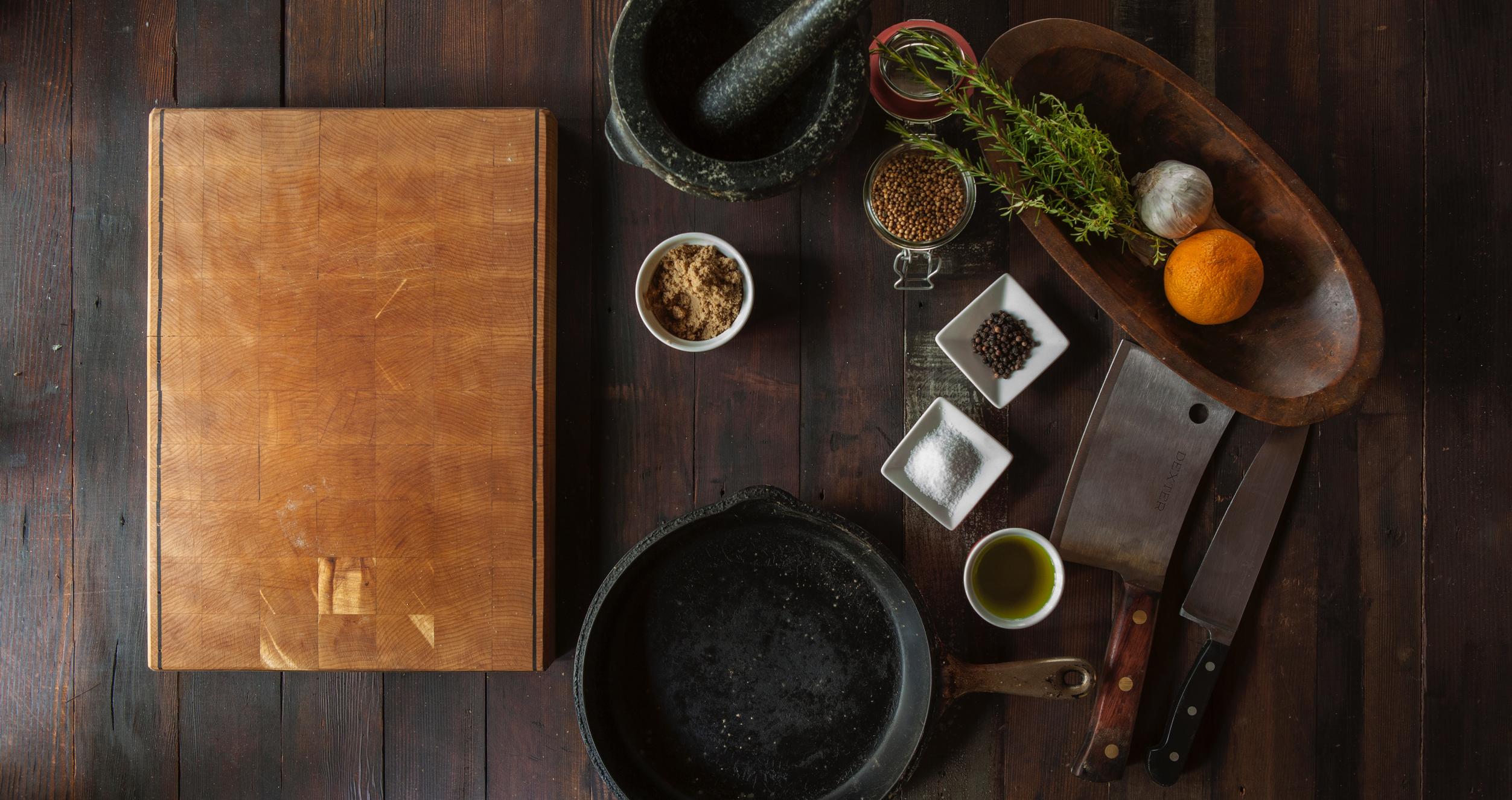 black mortar and pestle beside brown box in top view photography