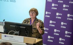 carol robbins speaking at a podium