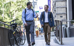 Two students walking on campus
