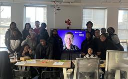 Students around a Zoom Screen w/ Dustin