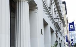 Column of a building and NYU flag
