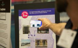 Person holds phone up to an interactive map