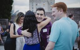 Alumni gather at an Outclass rooftop soiree