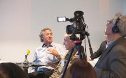 Harry Chernoff speaking and being recorded by a camera