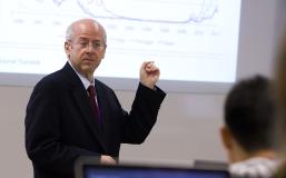 Kim Schoenholtz points at a projection of a graph