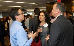 Three people with drinks, talking