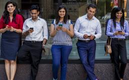 Students on their phones in Gould Plaza