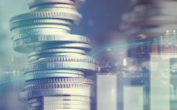 Double exposure of city and graph on rows of coins for finance and banking concept